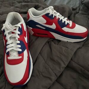 White,red and blue low rise Nike sneaker. Barley worn.
